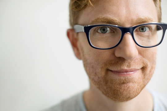 Close up portrait of smiling man wearing eyeglasses