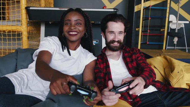 People are holding the joysticks. They are playing the game on a console. They are having fun.