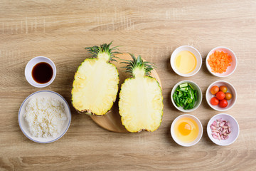 Thai food, pineapple fried rice and recipes for cooking on wooden background, vegetarian food