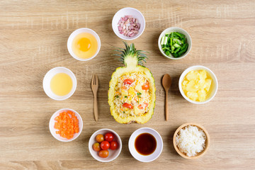 Thai food, pineapple fried rice and recipes for cooking on wooden background, vegetarian food