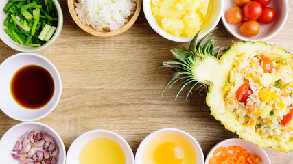 Thai food, pineapple fried rice and recipes for cooking on wooden background, vegetarian food