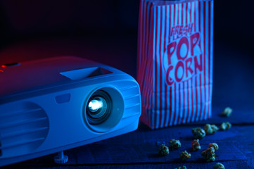 Background and film. Watching films. Projector and popcorn. Home rest and relaxation in the cinema.