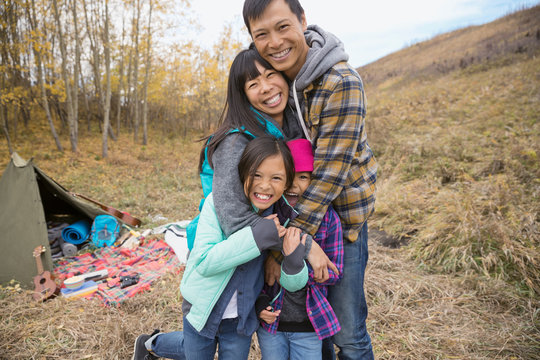 Portrait of family hugging at campsite