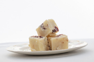 Plate of delicious white fudge with white background