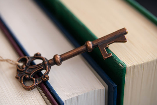 A old key on a stack of books