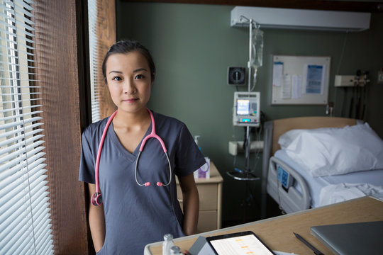 Portrait of confident nurse in hospital room