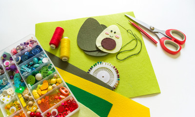 Fototapeta na wymiar Sewing avocado from felt. Children's creativity.