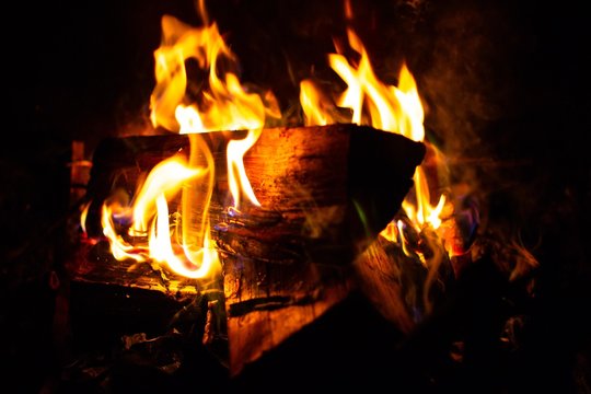 A Log Burning In A Charmin Fireplace