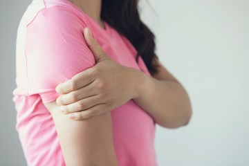 Woman have neck pain, shoulder pain in the  room.