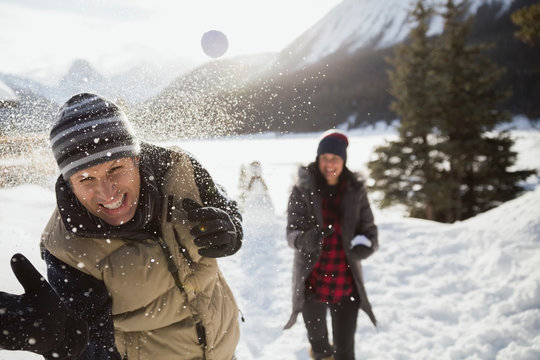 Couple enjoying snowball fight