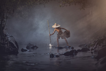 Asian boy fishing in the creek, Thailand countryside