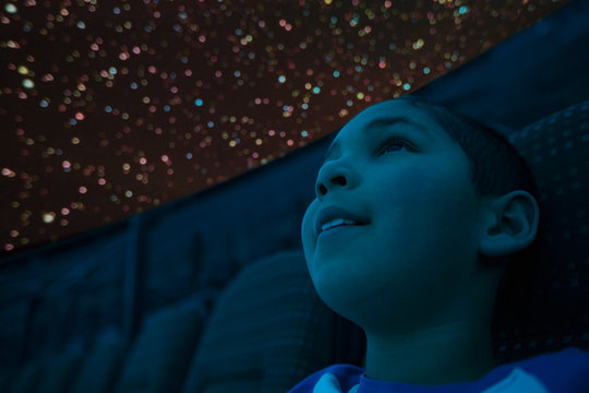 Close up of curious boy enjoying planetarium show
