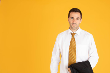 Portrait of confident businessman on yellow  background.