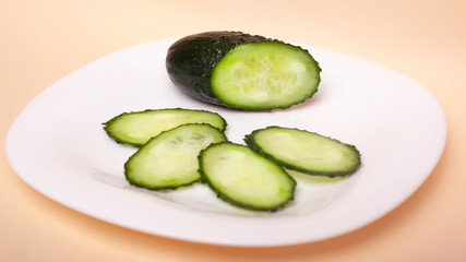 sliced fresh cucumbers on a white plate. chopped 
gherkins
