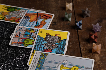 Fototapeta na wymiar Tarot Cards on cloth and wood magical items