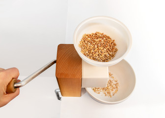 Grain roller or grain flaker. Used to make natural rolled oats. Hooper is filled with whole kernels of: oats, barley and farro. Healthy eating.