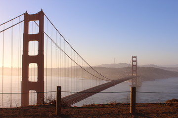 Beautiful golden gate bridge at sunrise on a foggy day
