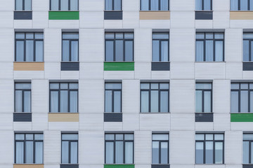 Front wall of an office building with windows and colored tiles