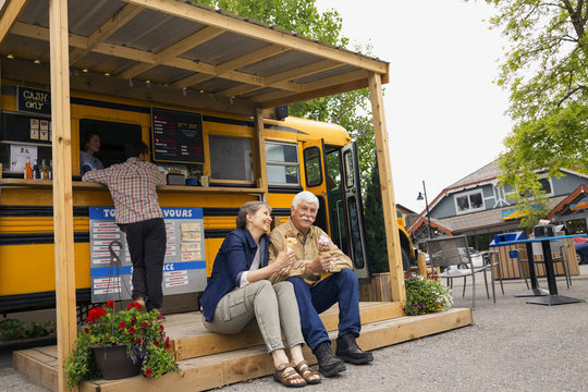 Older couple eating ice cream at food truck