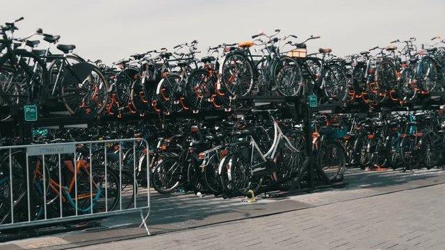 Amsterdam, Netherlands - April 24, 2019: A huge bunk parking for bicycles at the central railway station.