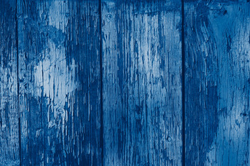 Fototapeta na wymiar Texture of old painted wood background closeup. empty template/ toned in classic blue trendy color of the year 2020