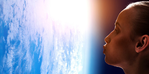 Girl kissing Earth planet . Mixed media