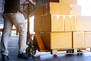 Workers Unloading Packaging Boxes on Pallets in The Warehouse. Cartons Cardboard Boxes. Shipping Warehouse. Delivery. Shipment Goods. Supply Chain. Distribution Warehouse Logistics Cargo Transport.	