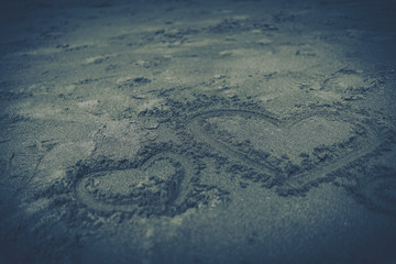 Heart drawn in the sand, concept of love.