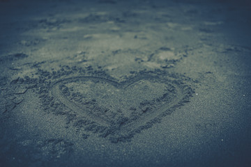 Heart drawn in the sand, concept of love.