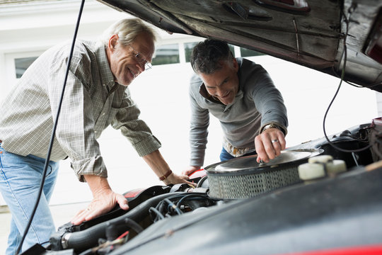 Father And Son Checking Engine Classic Car Driveway