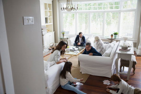 Multi-generation family hanging out in living room