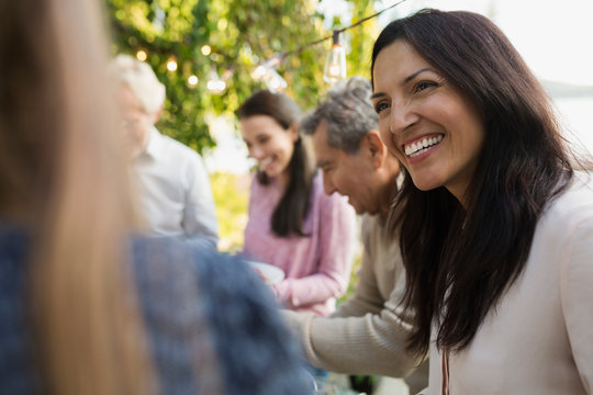 Smiling Woman Talking At Social Gathering