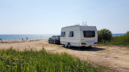 trailer caravan car by the sea, holidays in the nature outdoor by the sea - obrazy, fototapety, plakaty