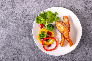 Salmon steak grilled with vegetables. Healthy food concept.