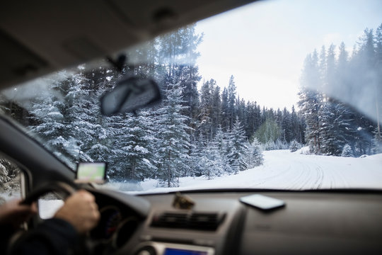 Man driving along snowy remote road