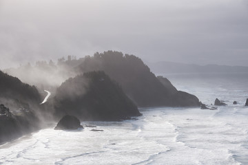 Morning mist clings to the capes around Short Beach, Oregon