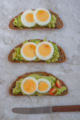 sliced avocado and egg on toasted bread for healthy breakfast or snack