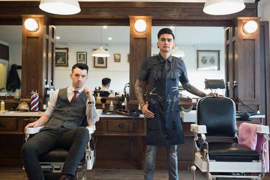Portrait confident barbers in barber shop