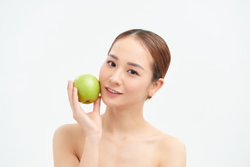 Pretty healthy young woman smiling holding a green apple