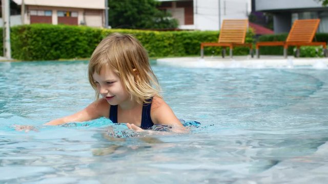 Child swims in the pool.