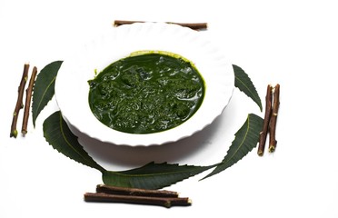 Medicinal ayurvedic azadirachta indica or Neem leaves with neem paste isolated on white background