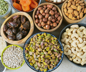 fresh nuts and dried fruis on granite surface