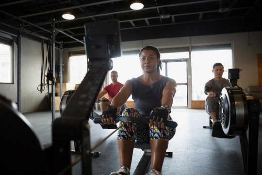 Woman using rowing machine at gym