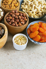 fresh nuts and dried fruis on granite surface