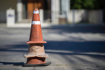 Old traffic cones mounted on road closures in the park.
