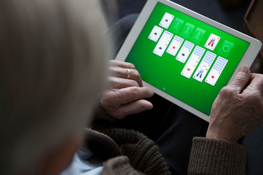 Close Up Senior Man Playing Solitaire On Digital Tablet