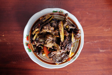 Fototapeta na wymiar Tengkleng Kambing Pak manto, Solo, Central Java, Indonesia. Traditional Indonesian spicy food made from the bones of goat.