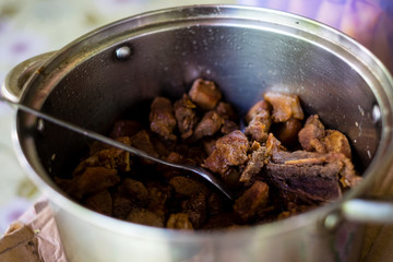Homemade Pork Adobo, in a stainless pot, is a popular Filipino dish and served as main course. Usually marinated before cooking or stewed to near dry. Selected focus. Copy space.