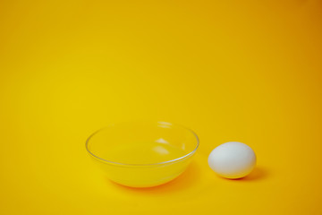 Happy Easter card with copy space. White eggs on orange background. Eggs painting process in orange paint.