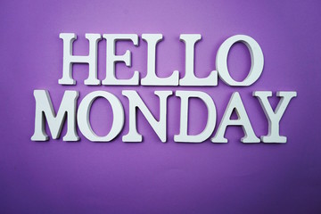 Obraz premium Hello Monday wooden letter alphabet on purple background